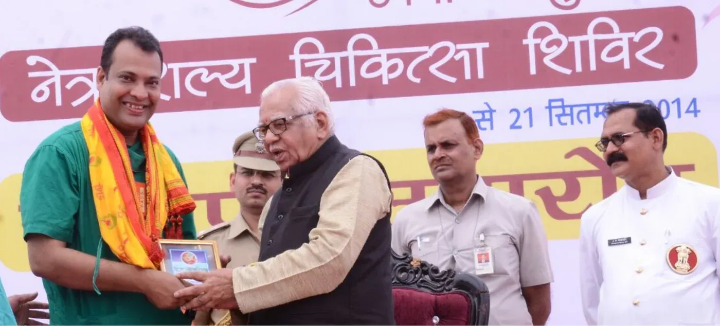 Dr. Anand Jaypuriya receiving an honour at a community health programme